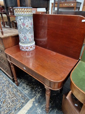 Lot 1046 - A Late Georgian mahogany fold over tea table...
