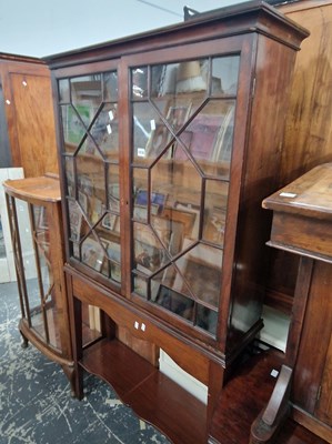 Lot 1076 - A 19th century glazed bookcase on a later stand