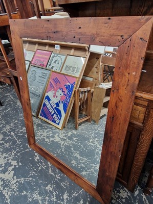 Lot 1071 - A large pine framed wall mirror