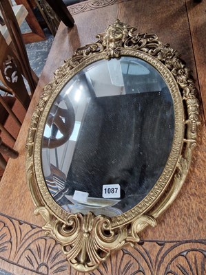 Lot 1087 - A decorative brass frame wall mirror