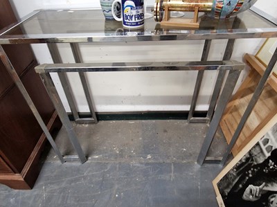 Lot 1104 - A retro chrome framed console table.