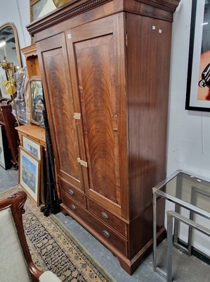 Lot 1105 - An antique mahogany wardrobe with hanging...