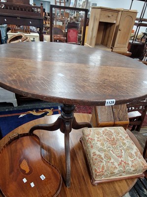 Lot 1129 - A Georgian oak tilt top tripod table.