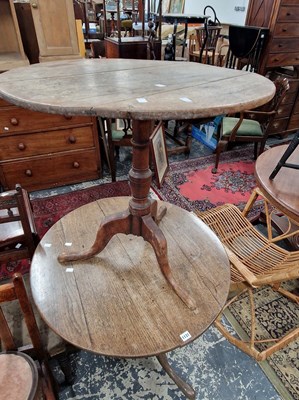 Lot 1131 - Two late 18th century oak tilt top tripod tables