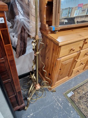 Lot 1145 - An antique brass standard lamp.