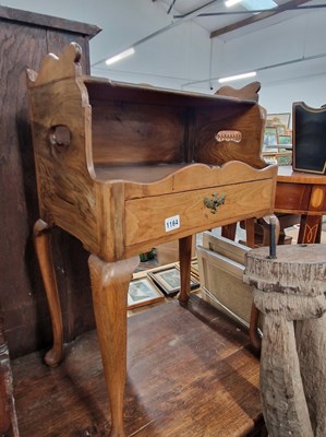 Lot 1164 - An antique walnut bedside night stand.
