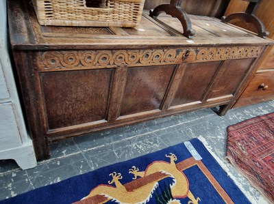 Lot 1178 - An 18th century oak coffer with carved frieze...