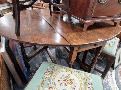 Lot 1197 - A large 18th century oak gateleg dining table...