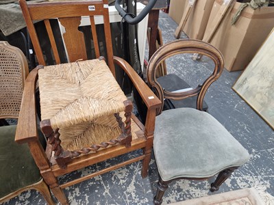 Lot 1226 - An early 20th century oak armchair, a balloon...