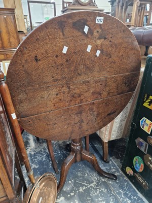 Lot 1242 - An 18th century oak tilt top tripod table.