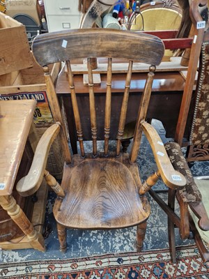 Lot 1270 - An antique slat back kitchen armchair.
