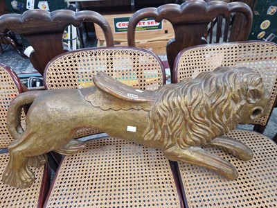 Lot 1290 - A gilt decorated carved figure of a lion.
