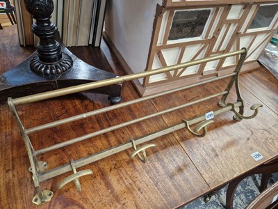 Lot 1295 - A vintage brass coat and hat rail.