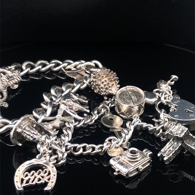 Lot 134 - Two vintage silver charm bracelets with...