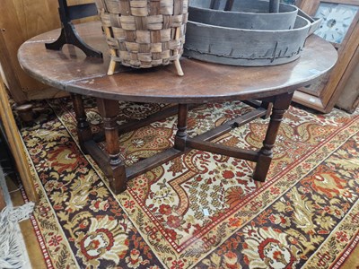 Lot 1334 - An oak oval drop leaf coffee table in the...
