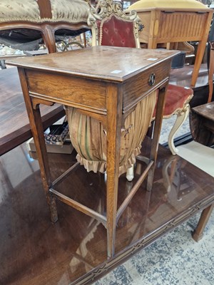 Lot 1355 - An oak sewing table.