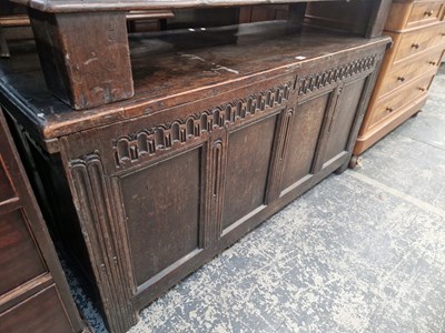 Lot 1419 - An 18th century oak coffer with carved frieze...