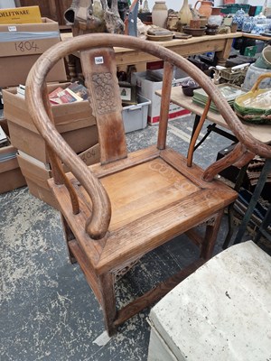 Lot 1430 - An antique Chinese horseshoe back armchair.