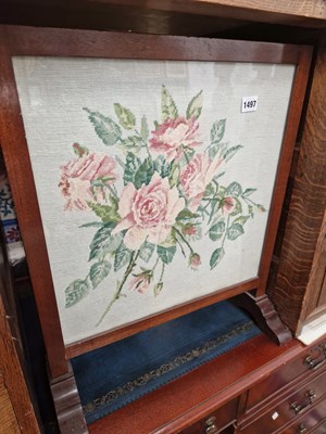 Lot 1497 - An embroidered firescreen.