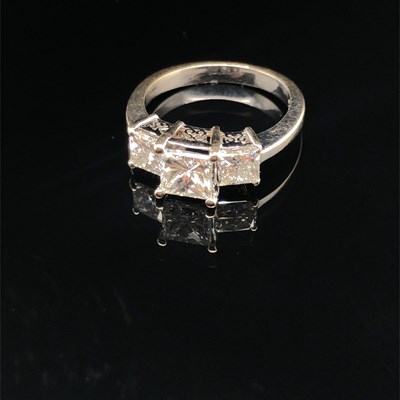 Lot 182 - A three-stone princess-cut diamond ring. The...