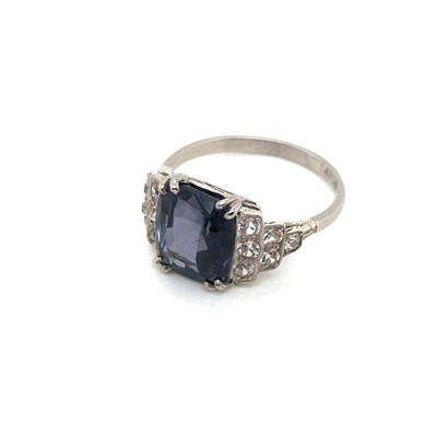 Lot 185 - A spinel and white sapphire ring. The central...