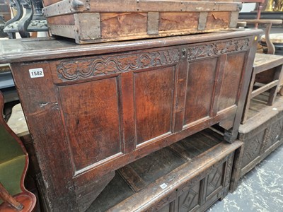 Lot 1582 - An early 18th century oak coffer. Carved...