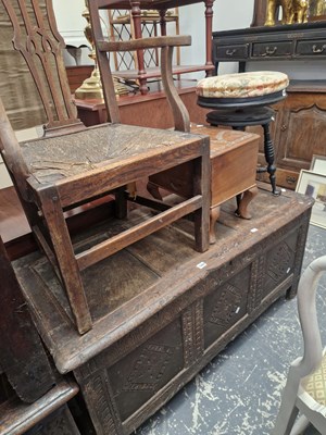 Lot 1584 - An 18th century oak coffer with three carved...