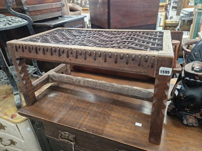 Lot 1595 - A carved hardwood stool with leather strung seat.