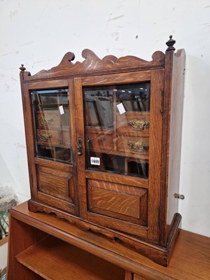 Lot 1600 - A late victorian oak smokers cabinet.