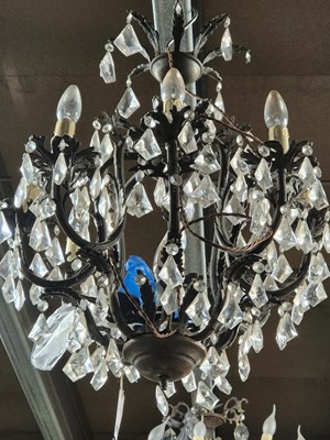Lot 970 - A cast metal and glass nine light chandelier