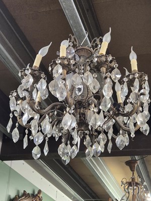 Lot 969 - A cast metal and glass ten arm chandelier