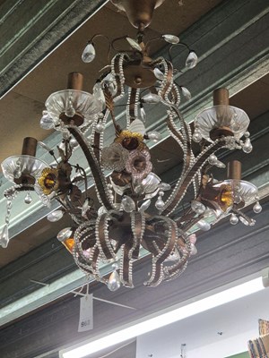 Lot 968 - A metal and glass six light chandelier