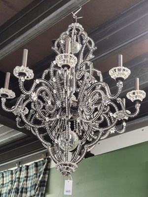 Lot 965 - A glass and metal nine-arm chandelier. Drop...