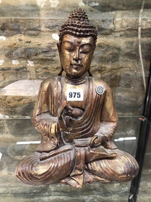 Lot 975 - A carved and gilded figure of a seated Buddha