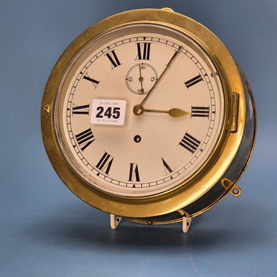 Lot 245 - A brass cased ship's wall clock, the painted...