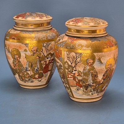 Lot 347 - A pair of Satsuma jars and covers painted on...