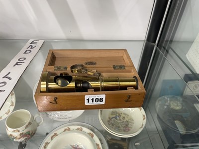 Lot 1106 - A wooden boxed student's microscope