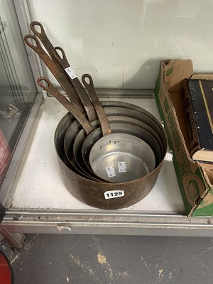Lot 1125 - A nest of five copper saucepans
