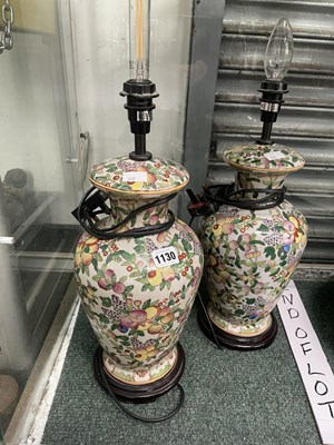 Lot 1130 - A pair of fruit decorated baluster vases as lamps