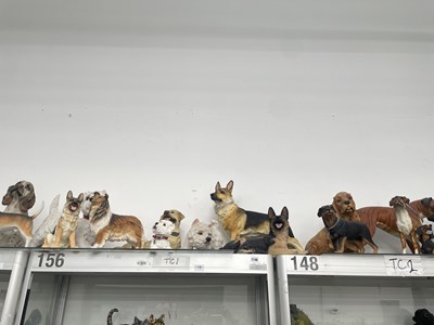 Lot 1146 - A large collection of composition dog figurines