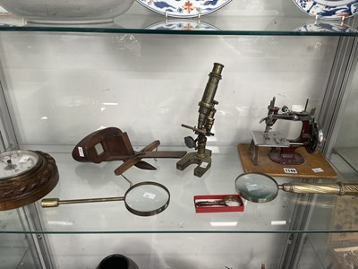 Lot 1149 - Three magnifying glasses, a microscope, a...