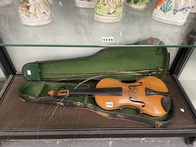Lot 1175 - A cased violin and bow