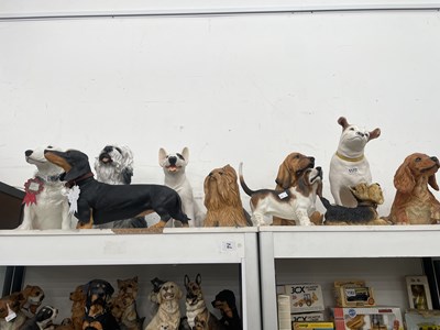 Lot 1177 - A collection of composition dogs of various...