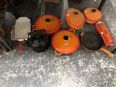 Lot 1295 - Orange enamelled iron cooking pots together...
