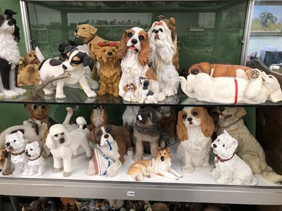 Lot 1330 - A collection of composition dog figurines by...