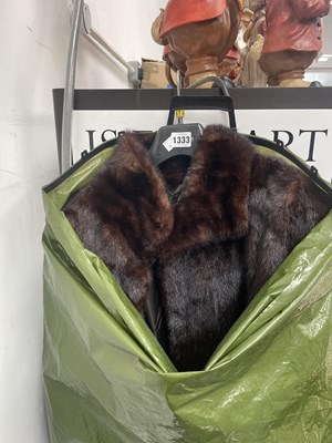 Lot 1333 - A fur coat together with two umbrellas