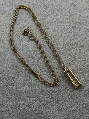 Lot 255 - A 9ct hallmarked gold ingot pendant and chain....