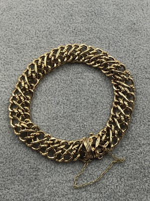Lot 258 - A 9ct hallmarked gold fancy link half-engraved...