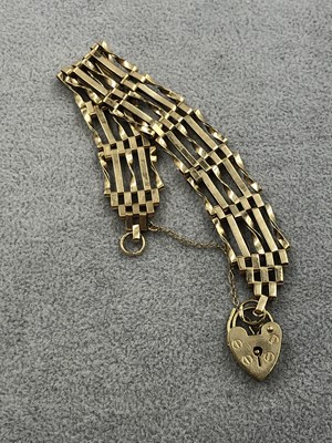 Lot 265 - A 9ct hallmarked gold five bar gate bracelet...