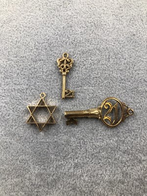 Lot 308 - Three gold charms. Two hallmarked 21 keys and...